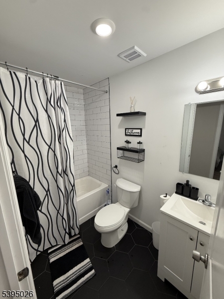 107 Willoughby Street, Unit 1 Newark, NJ 07112 - Photo 7 of 9 a bathroom with a toilet a sink and a mirror