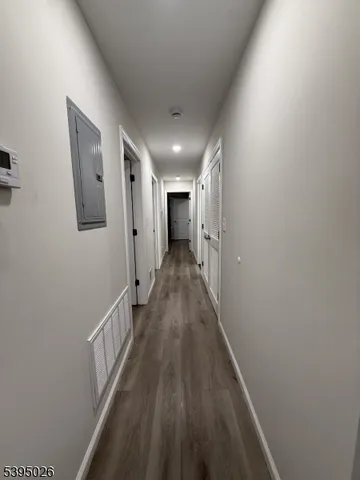 a view of a hallway with wooden floor