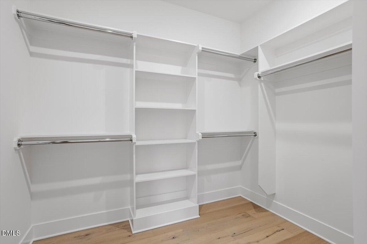 811 Maple Berry Lane, Unit 101 Raleigh, NC 27607 - Photo 28 of 45 a view of walk in closet with empty racks