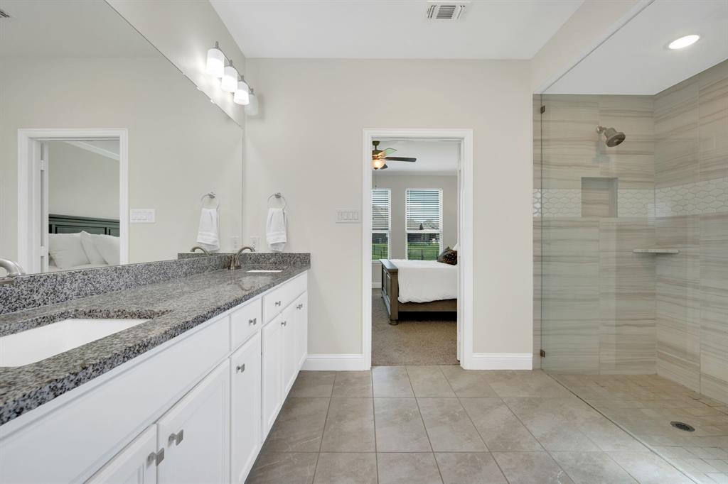 1601 Bear Path Way Gunter, TX 75058 - Photo 21 of 40 a spacious bathroom with a granite countertop sink a mirror and shower
