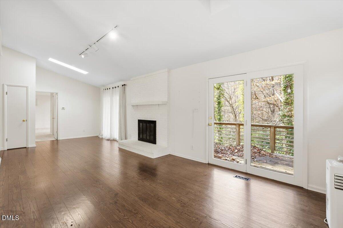620 Sugarberry Road Chapel Hill, NC 27514 - Photo 15 of 33 a view of an empty room with wooden floor and a window