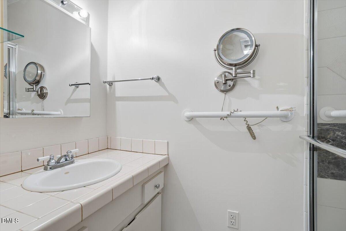620 Sugarberry Road Chapel Hill, NC 27514 - Photo 21 of 33 a bathroom with a sink and mirror