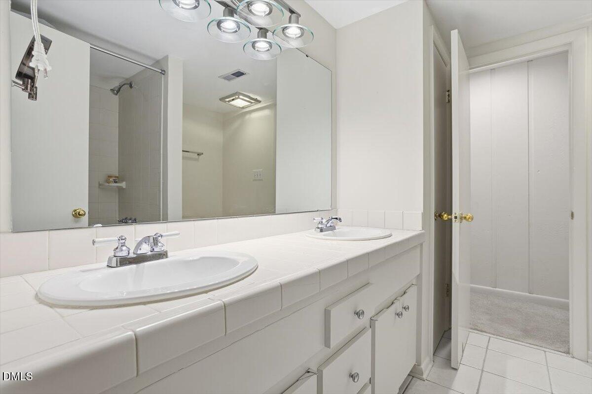 620 Sugarberry Road Chapel Hill, NC 27514 - Photo 26 of 33 a bathroom with a sink and a mirror