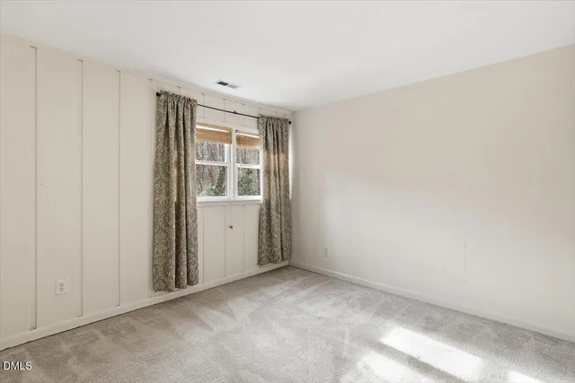 a view of wooden door and a window