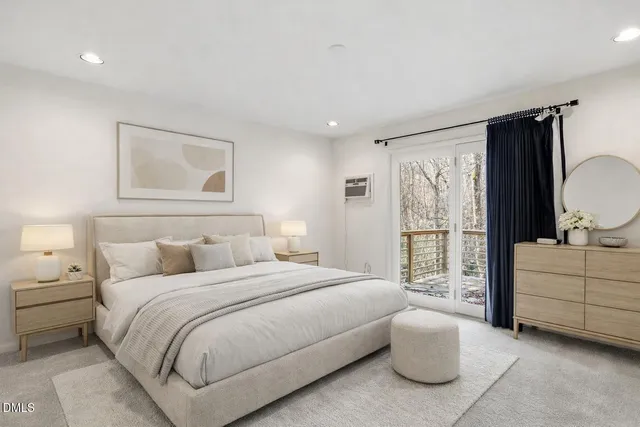 a bedroom with a bed and a large window