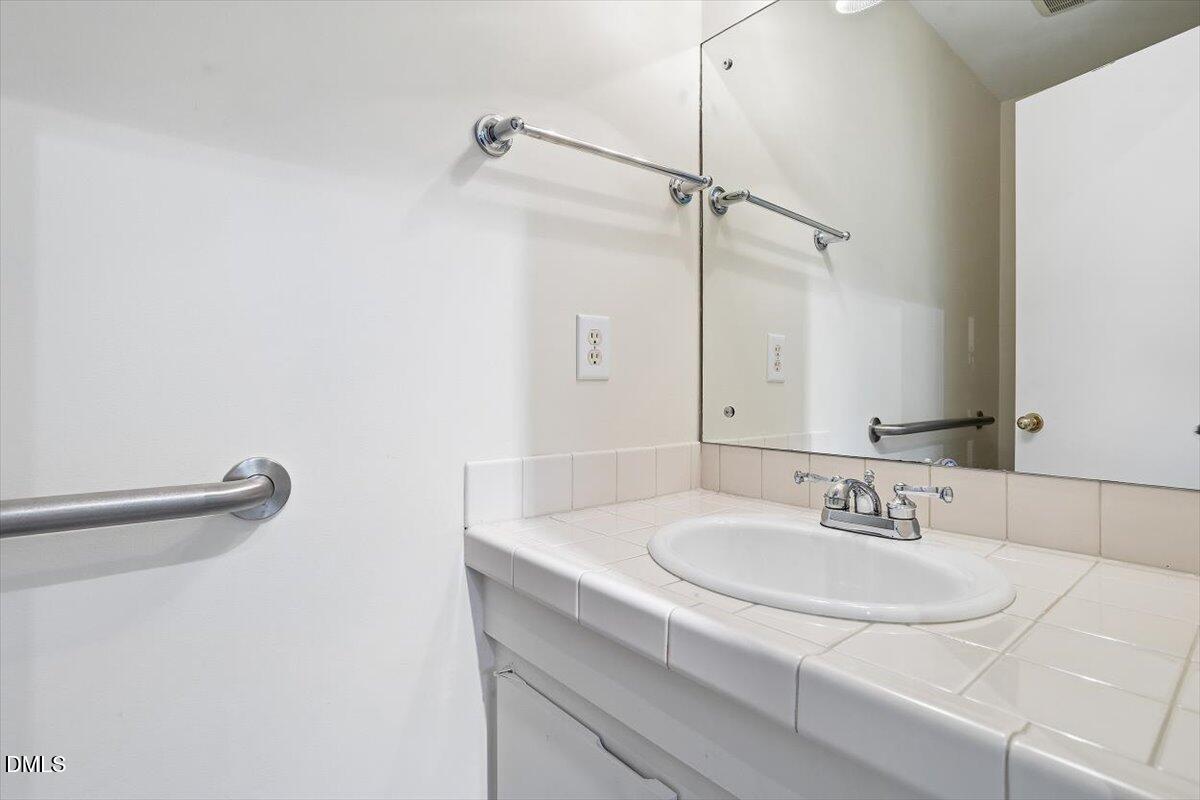 620 Sugarberry Road Chapel Hill, NC 27514 - Photo 9 of 33 a bathroom with a sink and a mirror