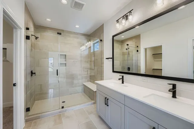 a bathroom with a shower sink and mirror
