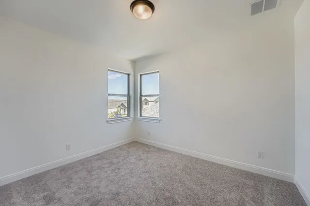 a bathroom with a double vanity sink a toilet and a shower