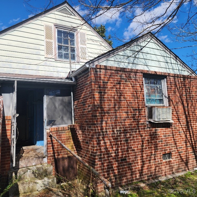 View of side of property featuring cooling unit