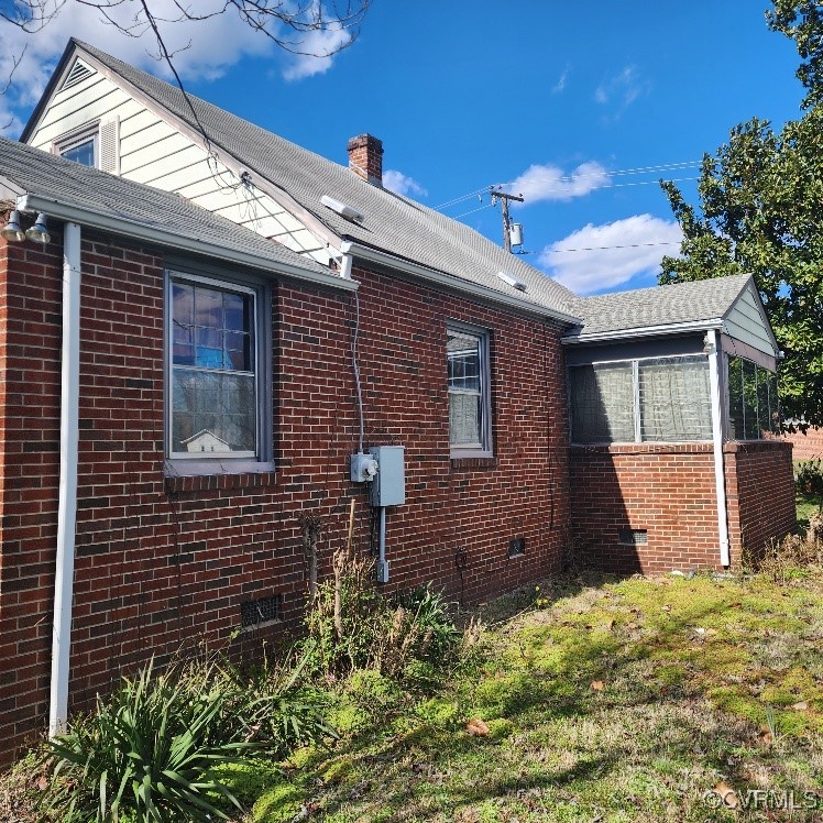View of side of property with a yard