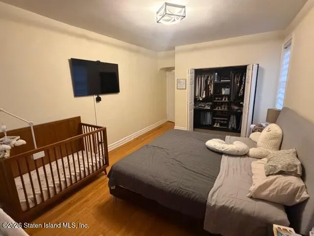 a bedroom with a bed and flat screen tv