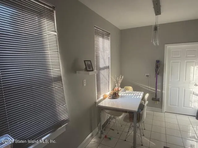 a view of a room that has a table and chairs in it