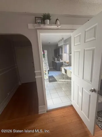 a view of a hallway to a livingroom with furniture