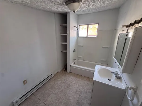 a bathroom with a sink a bathtub and a shower
