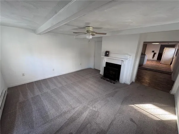 wooden floor in an empty room with a fireplace