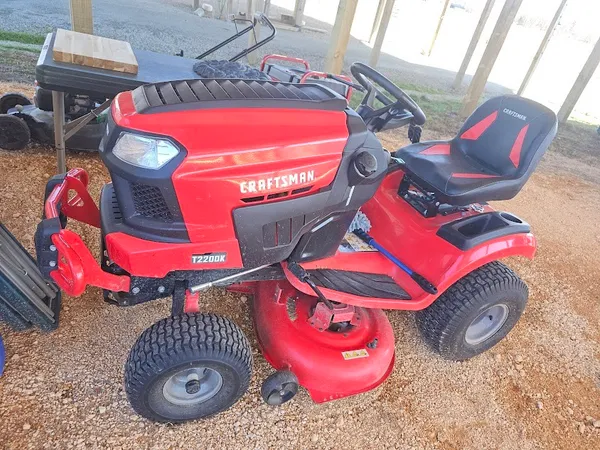 a view of a wooden fence with large trees