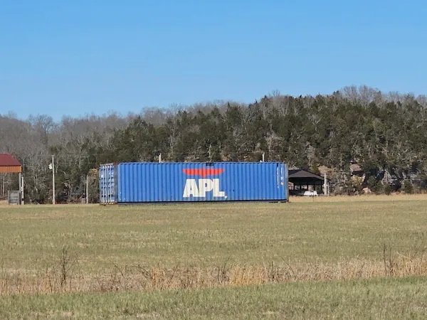 a kitchen with granite countertop a stove a sink and a microwave