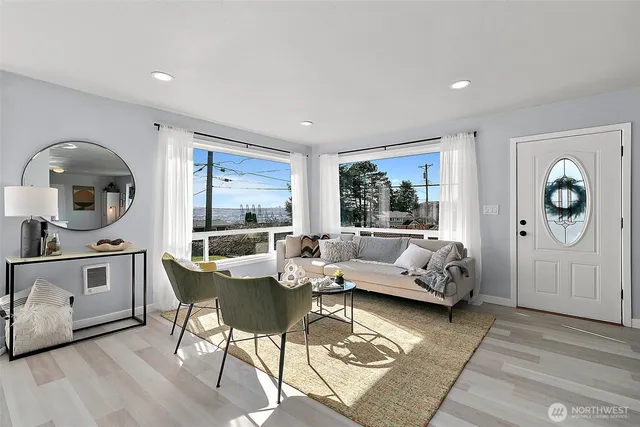 a living room with furniture and large window