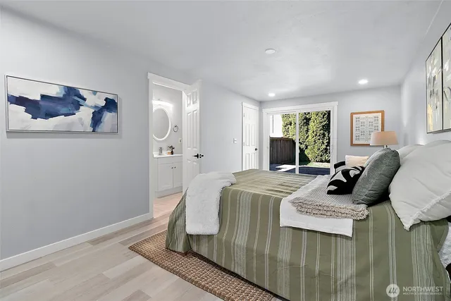 a bed room with a bed a couch and dresser