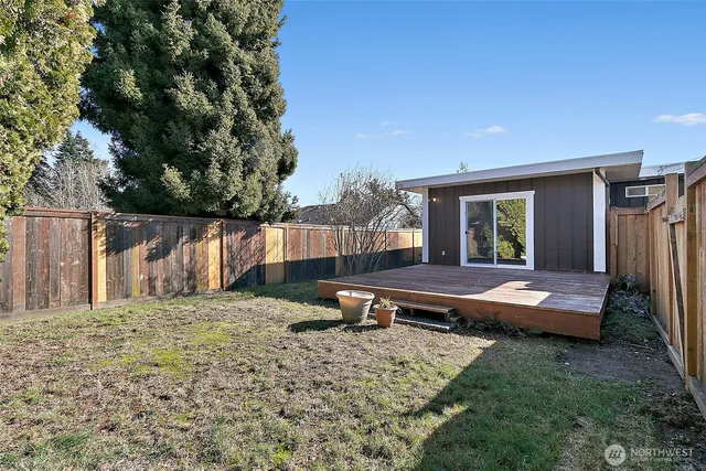 a backyard of a house with fountain table and chairs