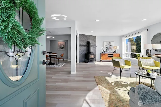 a living room with furniture a mirror and a chandelier