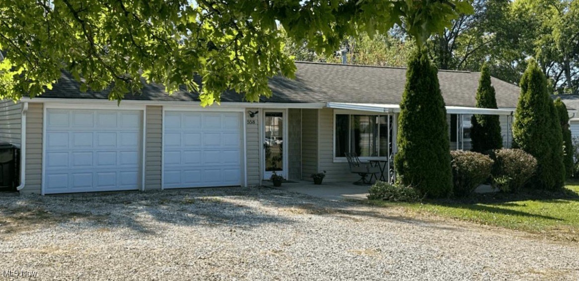 558 Frost Road Streetsboro, OH 44241 - Photo 1 of 32 Single story home with gravel driveway, an attached garage, roof with shingles, and covered porch