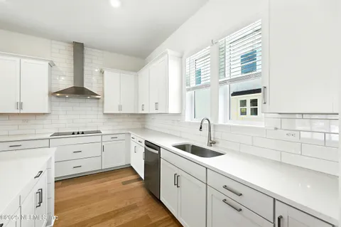 a kitchen with cabinets appliances a sink and a window