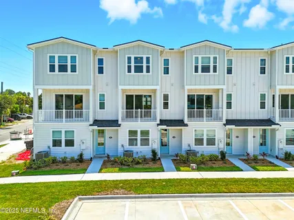 a front view of a residential apartment building with a yard