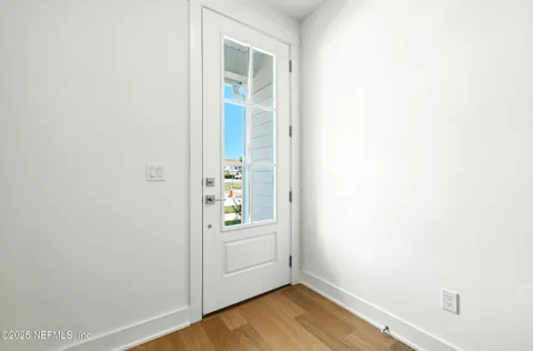 a view of an entryway with wooden floor