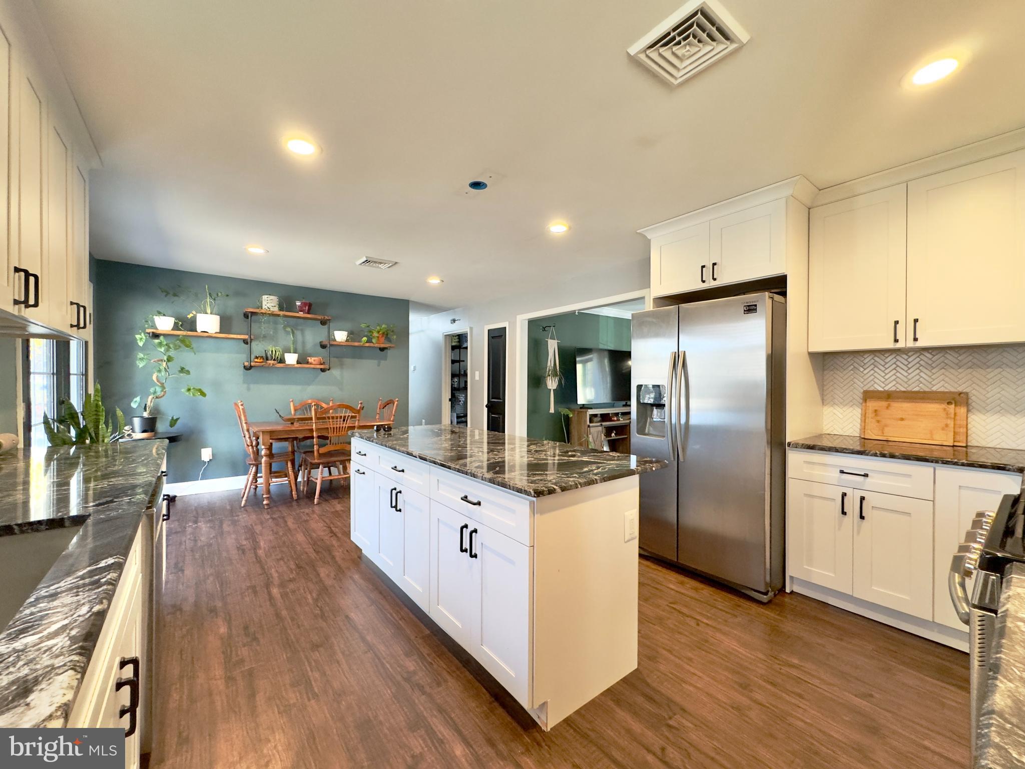 118 Timberlane Road Clarksboro, NJ 08020 - Photo 7 of 24 a kitchen with stainless steel appliances a refrigerator a stove a sink dishwasher and white cabinets with wooden floor
