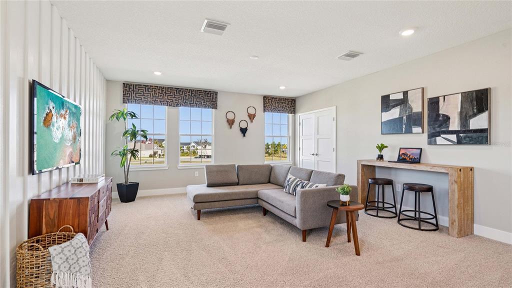 4265 Southwest 52nd Lane Road Ocala, FL 34474 - Photo 18 of 40 a living room with furniture and a painting on the wall