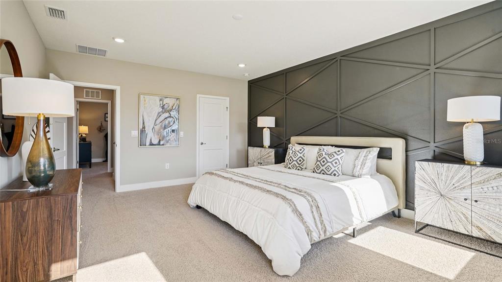 4265 Southwest 52nd Lane Road Ocala, FL 34474 - Photo 22 of 40 a bedroom with a bed and a lamp