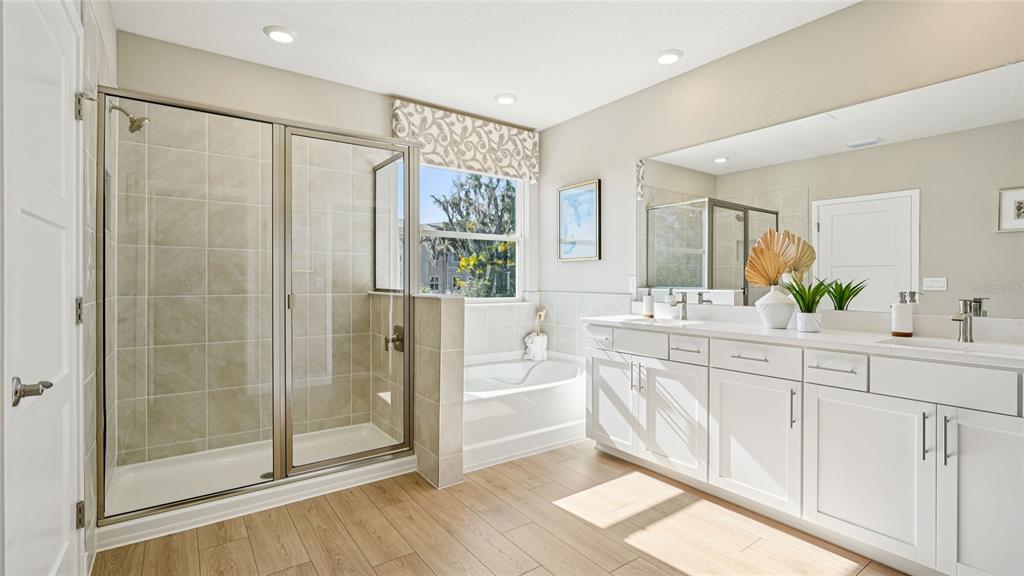 4265 Southwest 52nd Lane Road Ocala, FL 34474 - Photo 24 of 40 a spacious bathroom with a shower sink and mirror