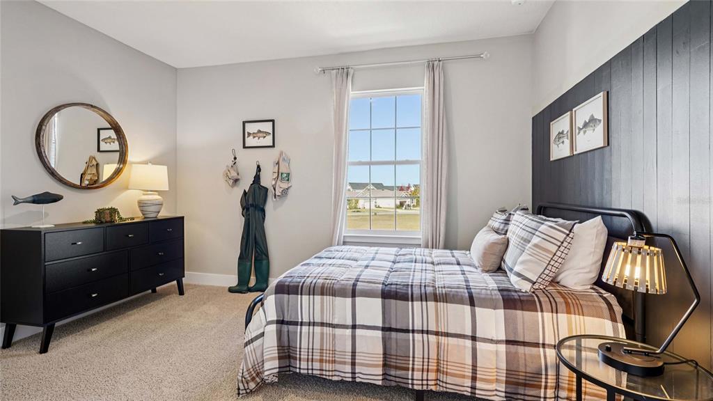 4265 Southwest 52nd Lane Road Ocala, FL 34474 - Photo 26 of 40 a bedroom with a bed and dresser