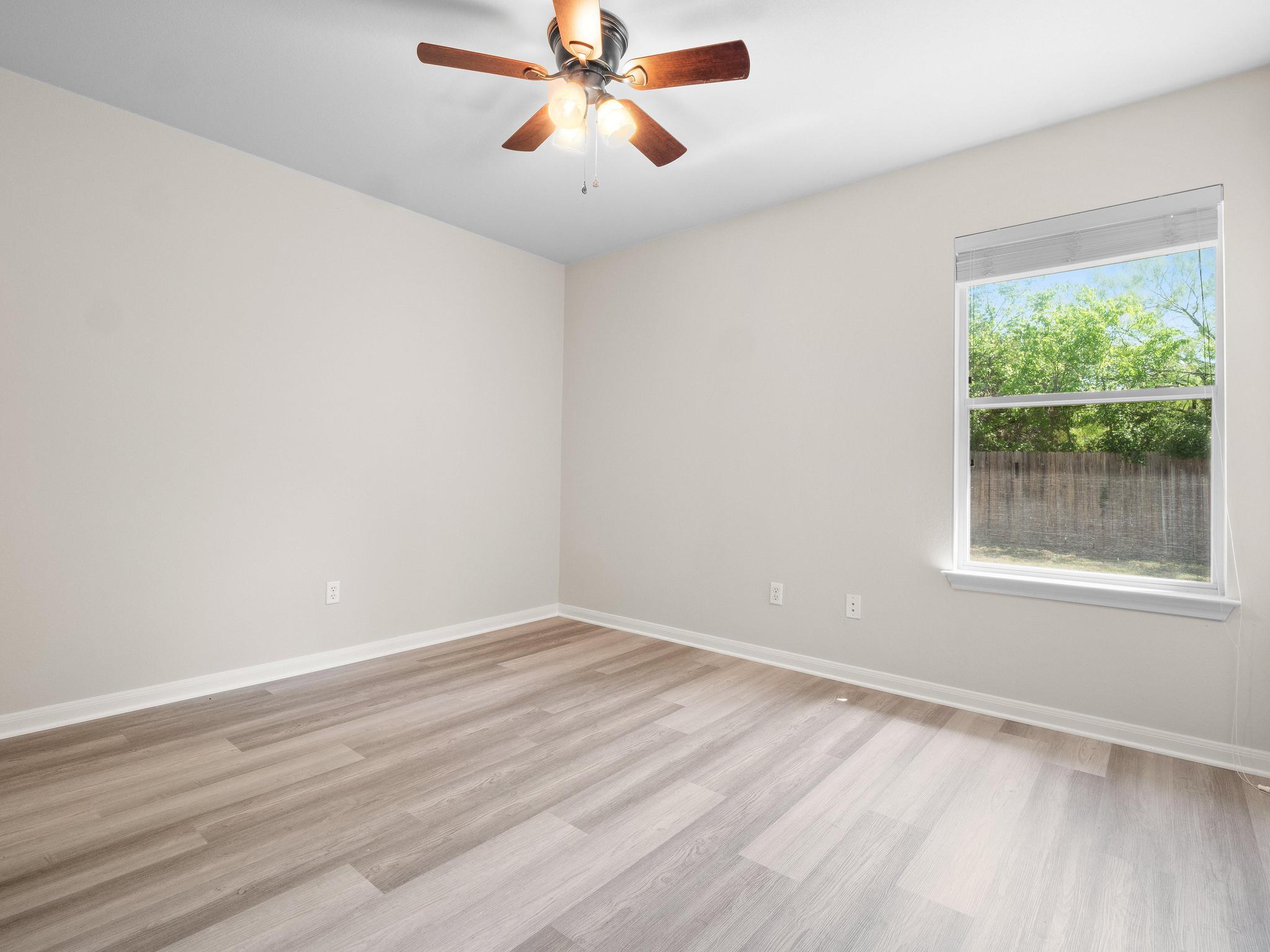 429 Falcon Lane Leander, TX 78641 - Photo 19 of 27 wooden floor in an empty room with a window