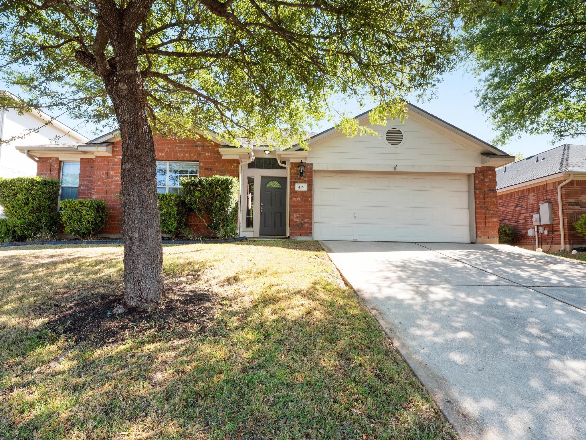 429 Falcon Lane Leander, TX 78641 - Photo 2 of 27 a front view of a house with a yard and garage