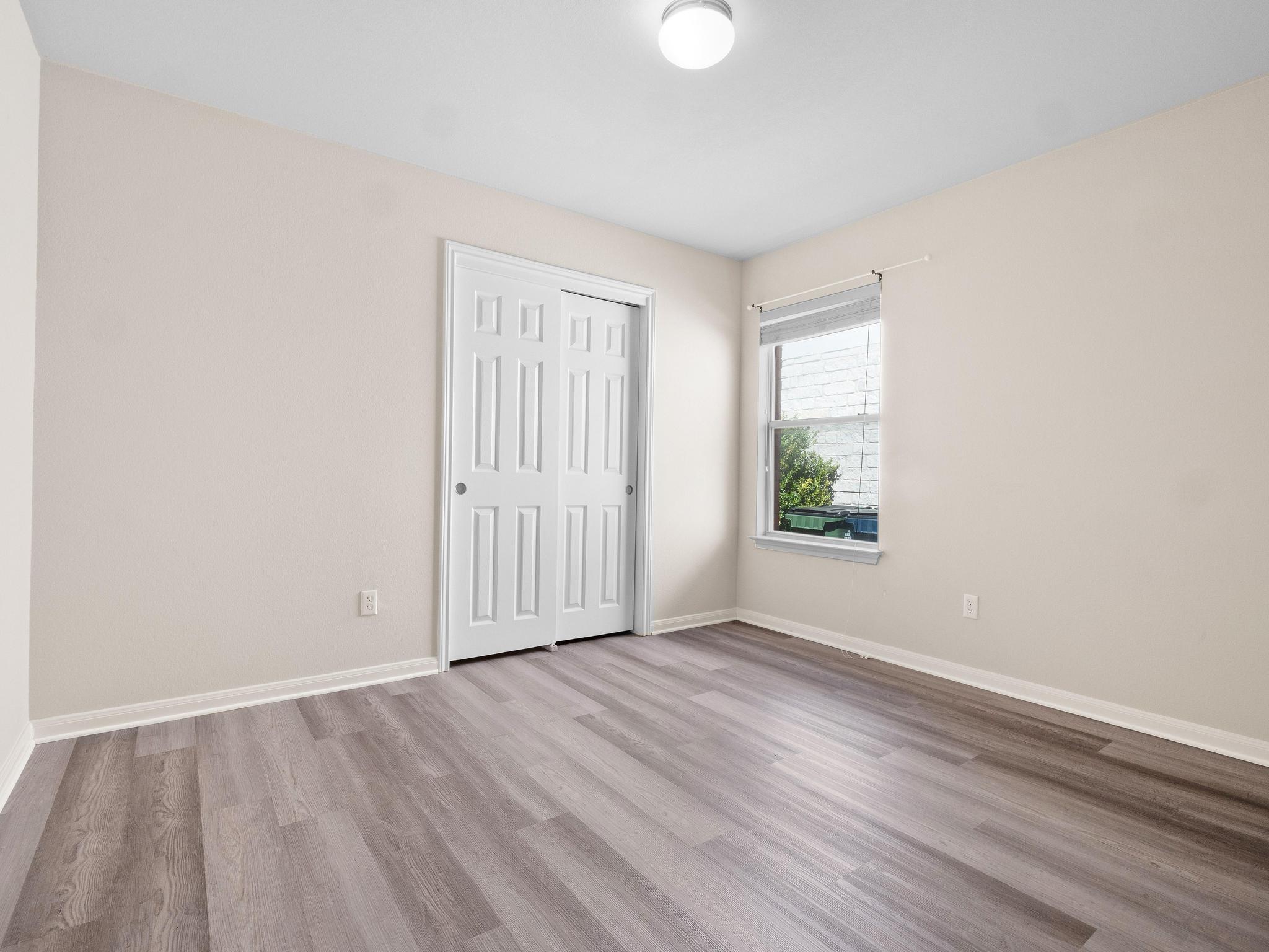 429 Falcon Lane Leander, TX 78641 - Photo 21 of 27 an empty room with wooden floor and windows