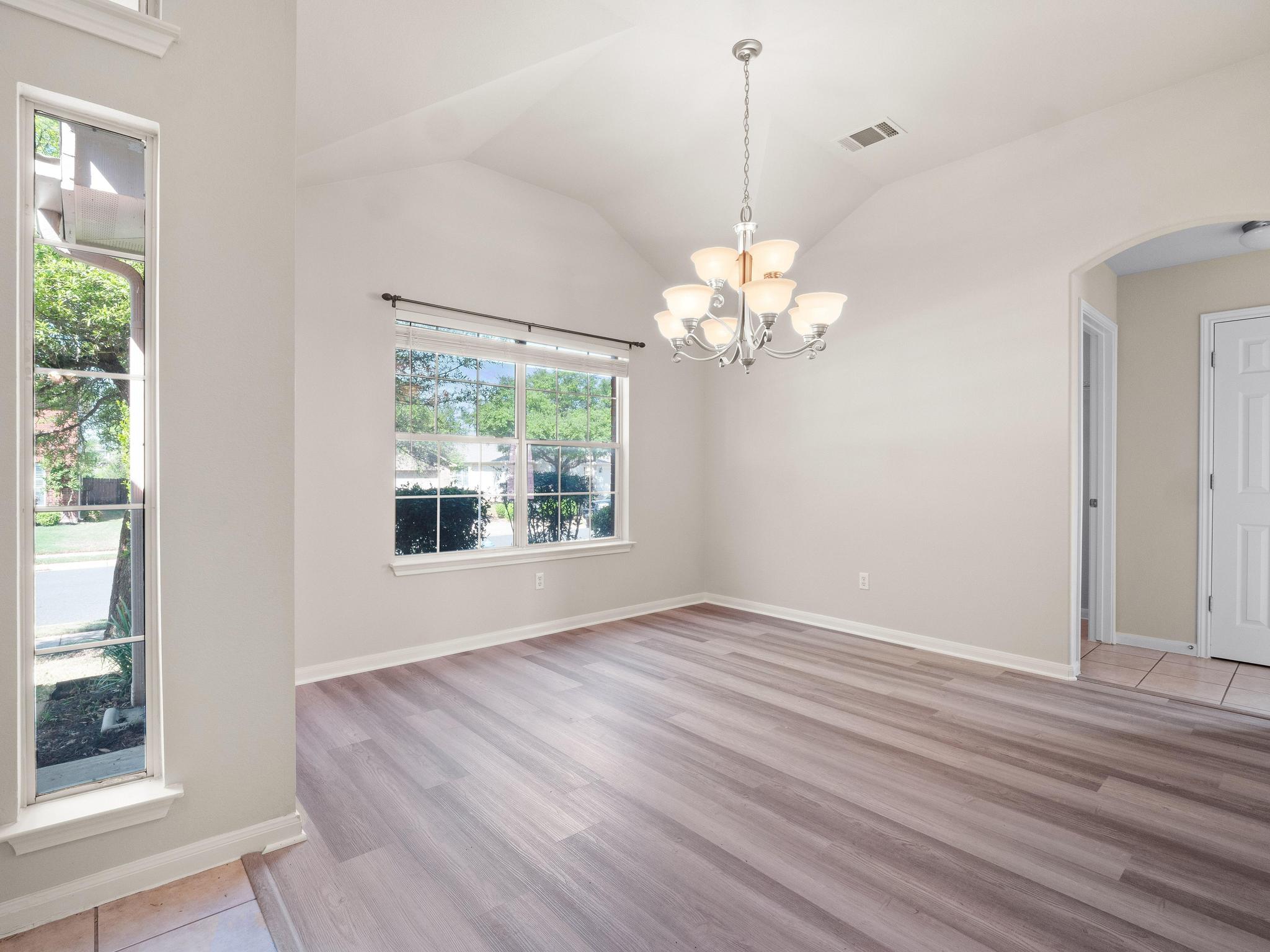 429 Falcon Lane Leander, TX 78641 - Photo 5 of 27 a view of an empty room with wooden floor and a window