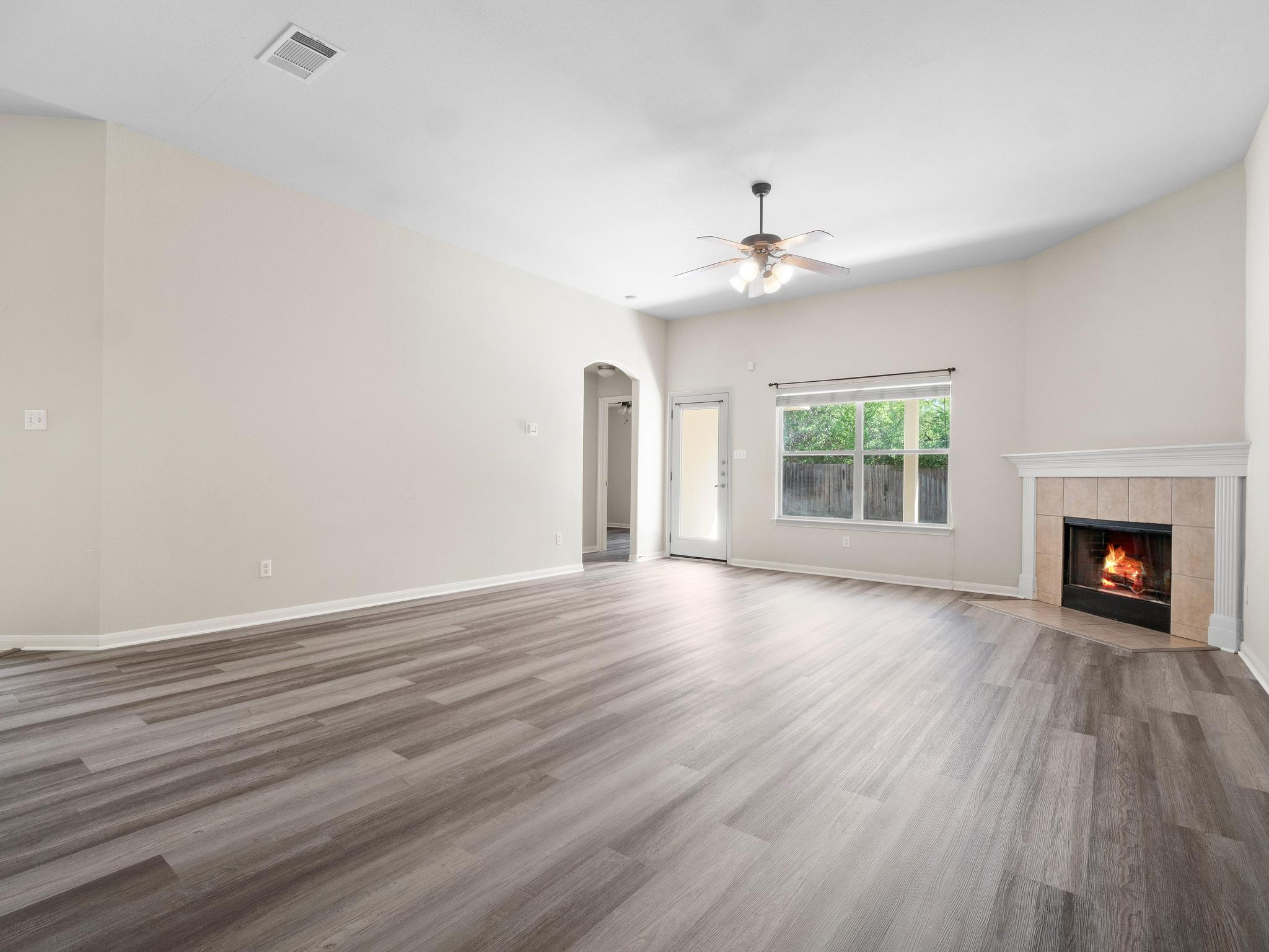 429 Falcon Lane Leander, TX 78641 - Photo 7 of 27 wooden floor in an empty room with a fireplace