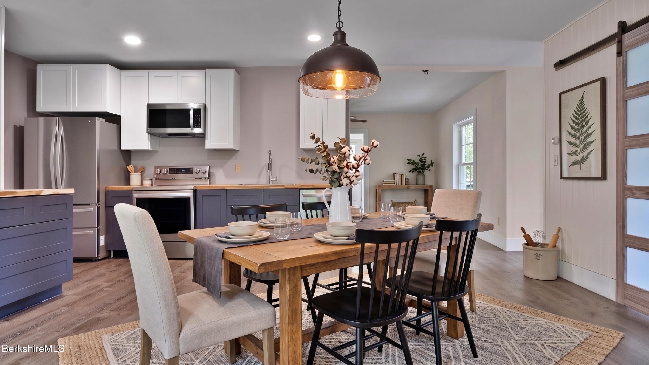 20 East Dugway Road Lenox, MA 01240 - Photo 33 of 84 a dining room with furniture a chandelier and wooden floor