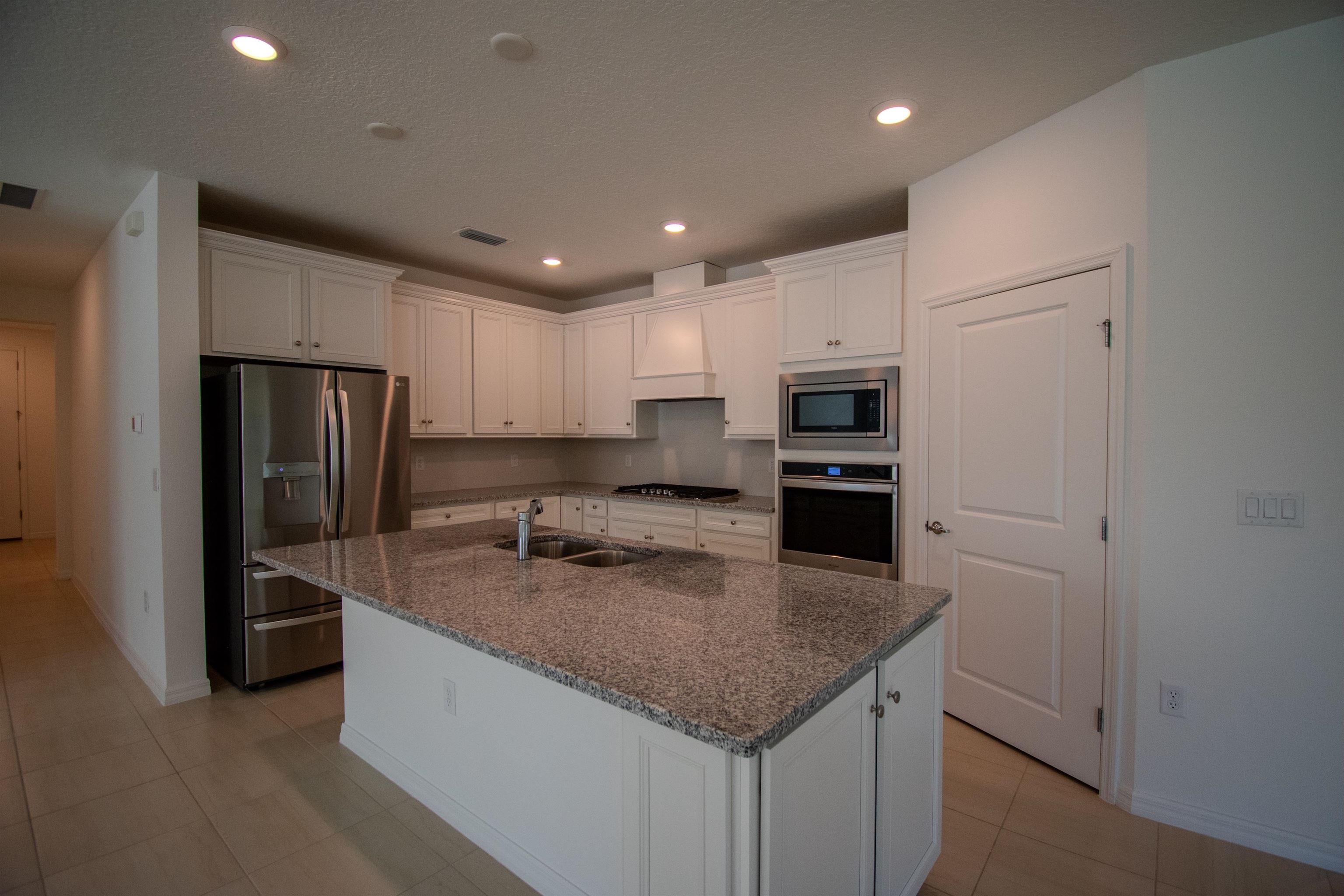436 Cedar Preserve Ln Street St. Augustine, FL 32095 - Photo 15 of 27 a kitchen with a refrigerator a microwave and stove