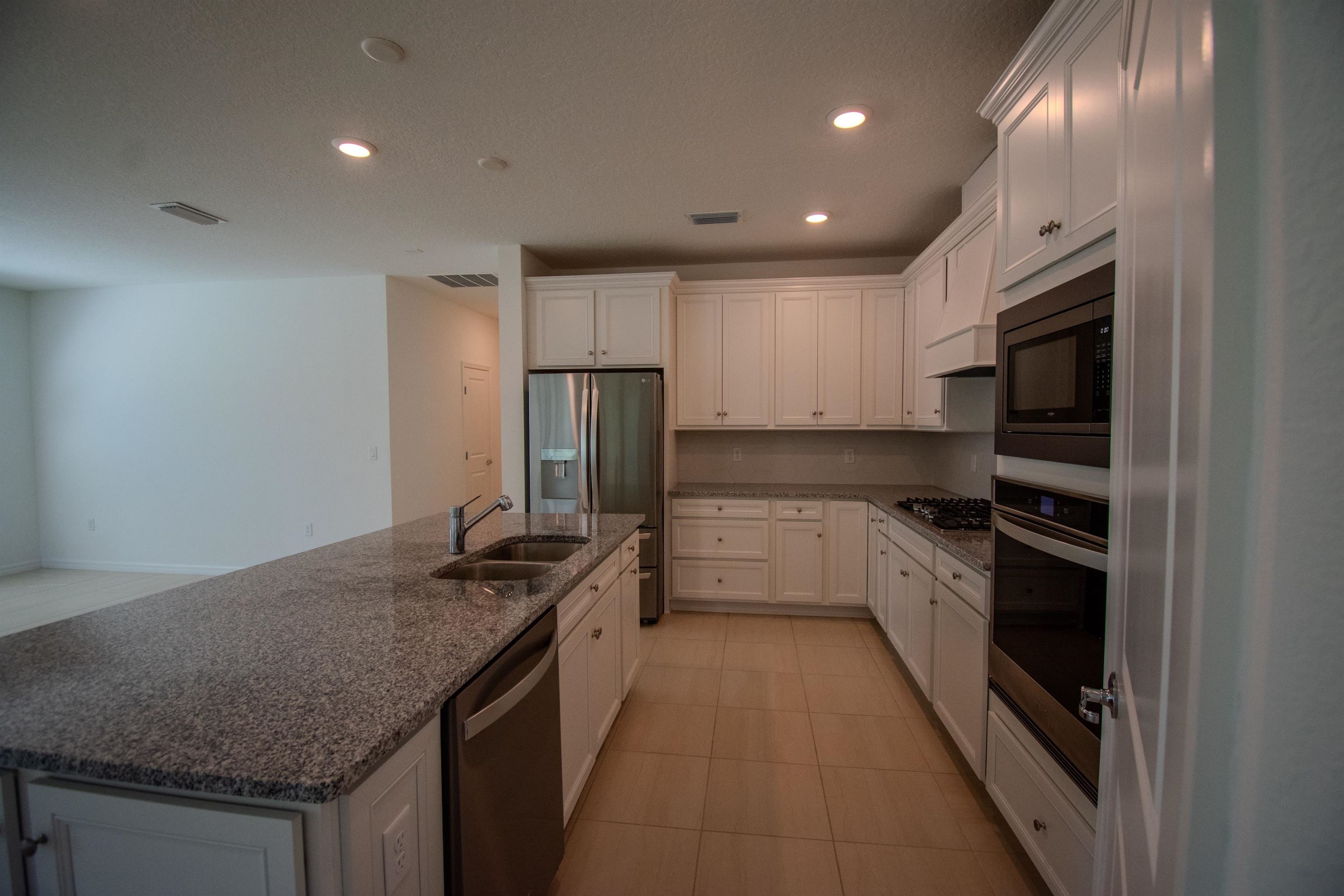 436 Cedar Preserve Ln Street St. Augustine, FL 32095 - Photo 16 of 27 a kitchen with stainless steel appliances granite countertop a sink stove and refrigerator