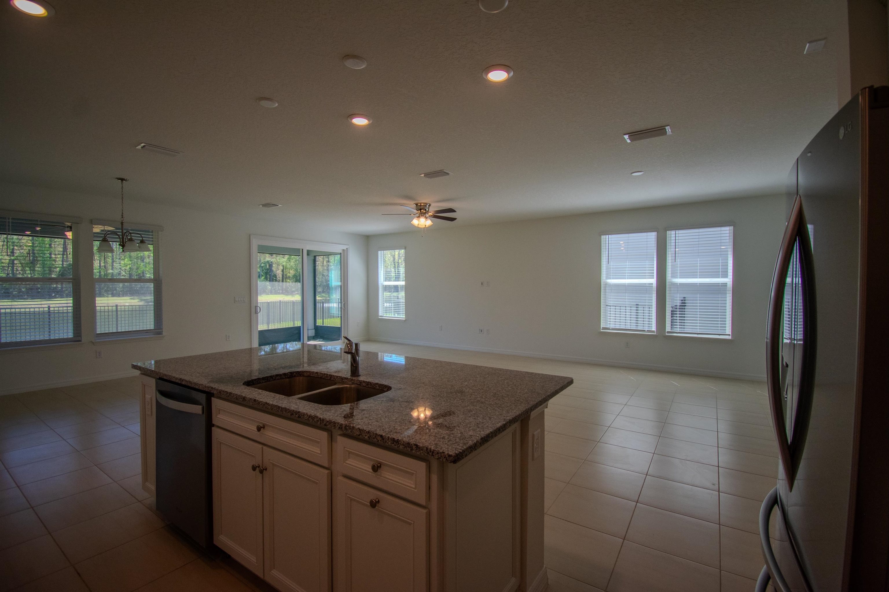 436 Cedar Preserve Ln Street St. Augustine, FL 32095 - Photo 17 of 27 a kitchen with granite countertop a sink and dishwasher with wooden floor