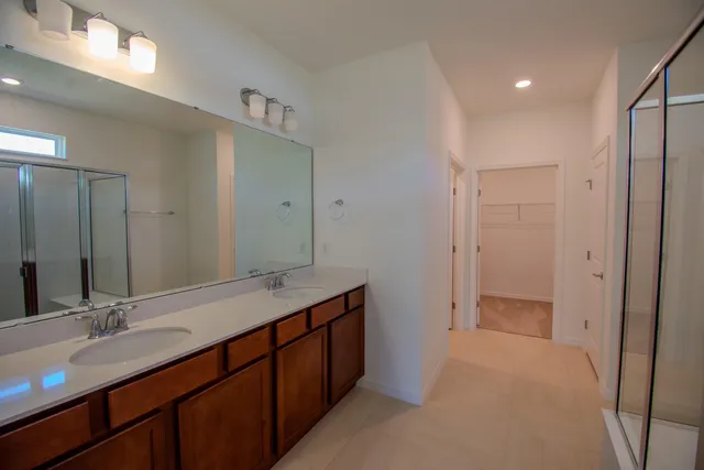 a bathroom with a double vanity sink and a mirror