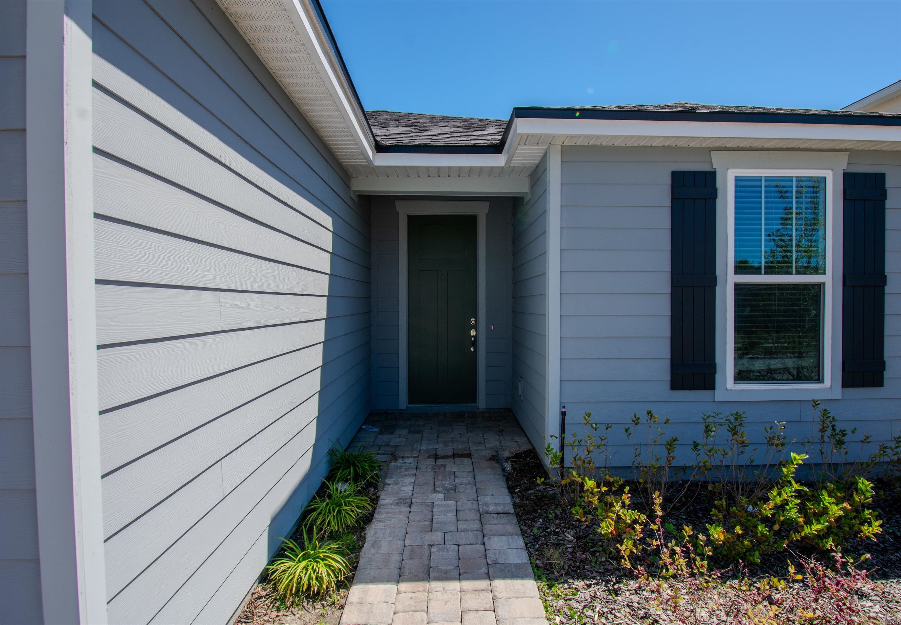 436 Cedar Preserve Ln Street St. Augustine, FL 32095 - Photo 2 of 27 a front view of a house with a garden