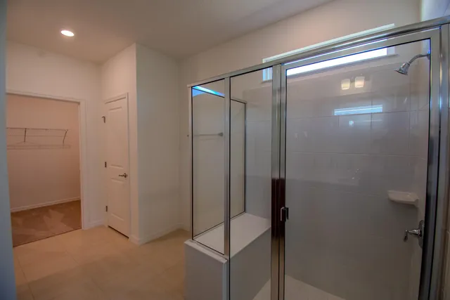 a bathroom with a glass shower door