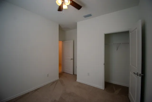 an empty room with a empty space and a ceiling fan