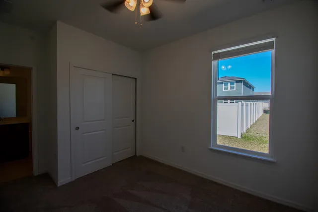 an empty room with a window and wooden floor