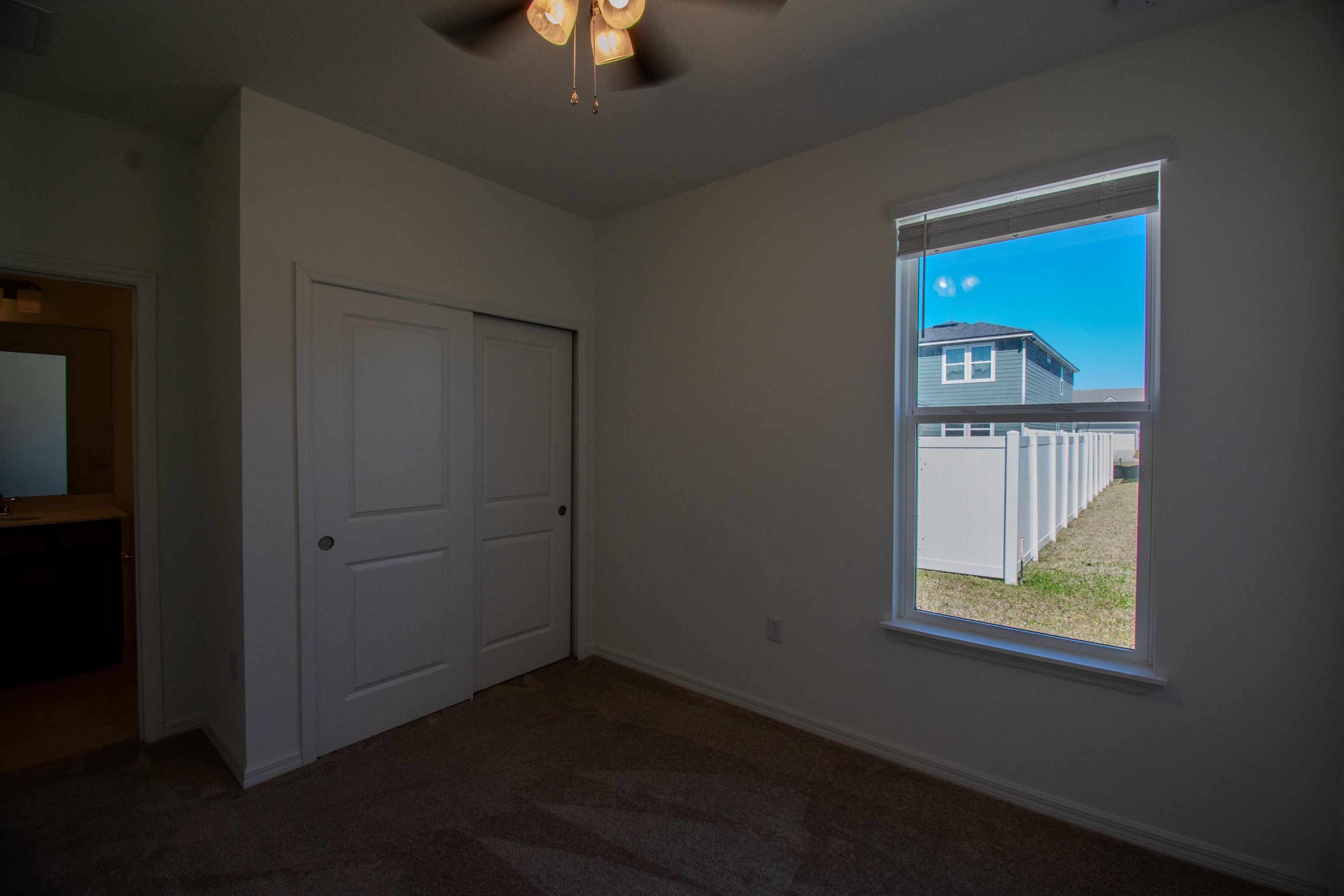 436 Cedar Preserve Ln Street St. Augustine, FL 32095 - Photo 10 of 27 an empty room with a window and wooden floor