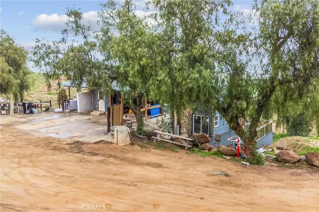 an aerial view of residential house with outdoor space and trees around